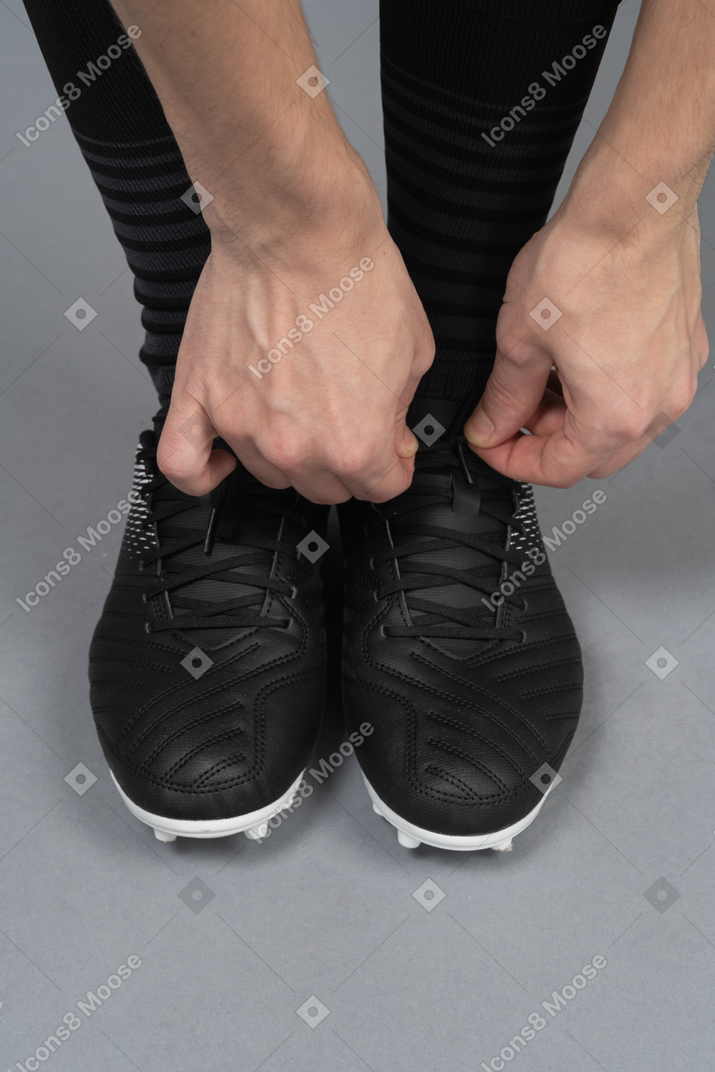 Close-up of a soccer player doing his shoelaces