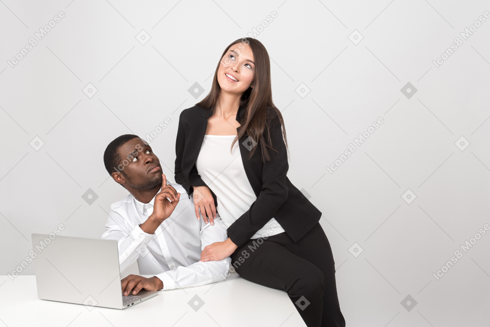 Attractive asian woman hugging her amazed collegue in the workplace