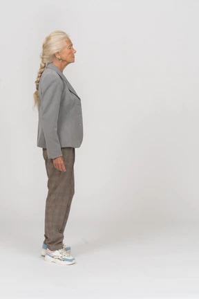 Old lady in suit standing in profile