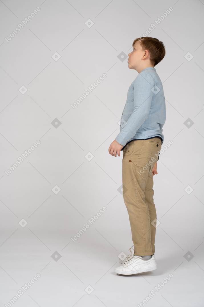 Boy standing and looking up