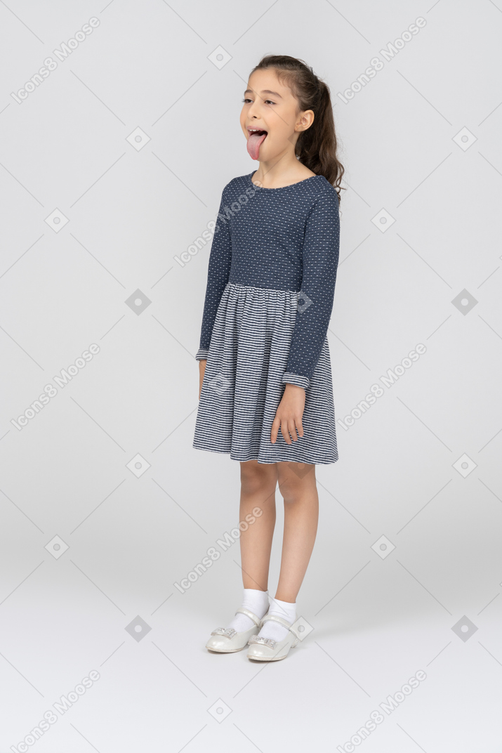 Three-quarter view of a girl showing tongue goofily