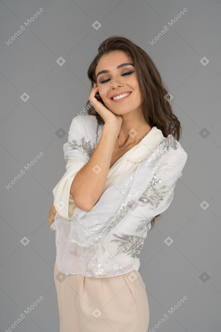 Pleased charming young woman dreaming with her eyes closed