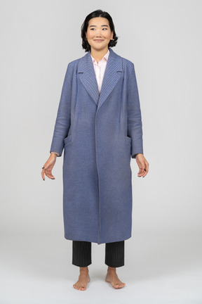 Woman in blue coat smiling cheerfully