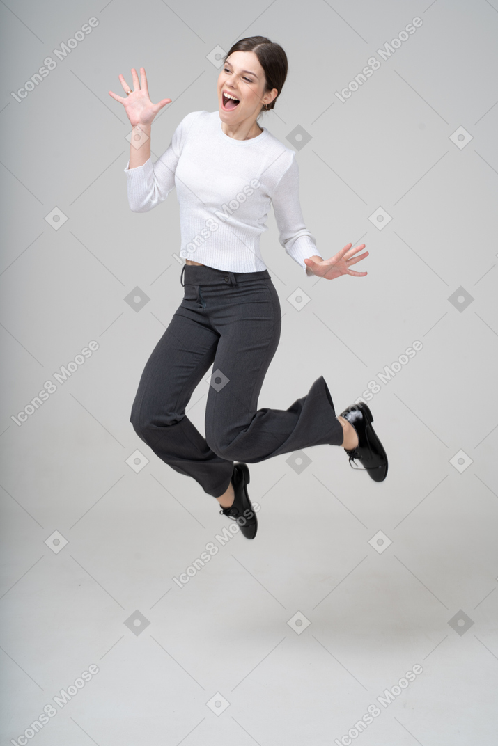 Front view of a woman in suit jumping