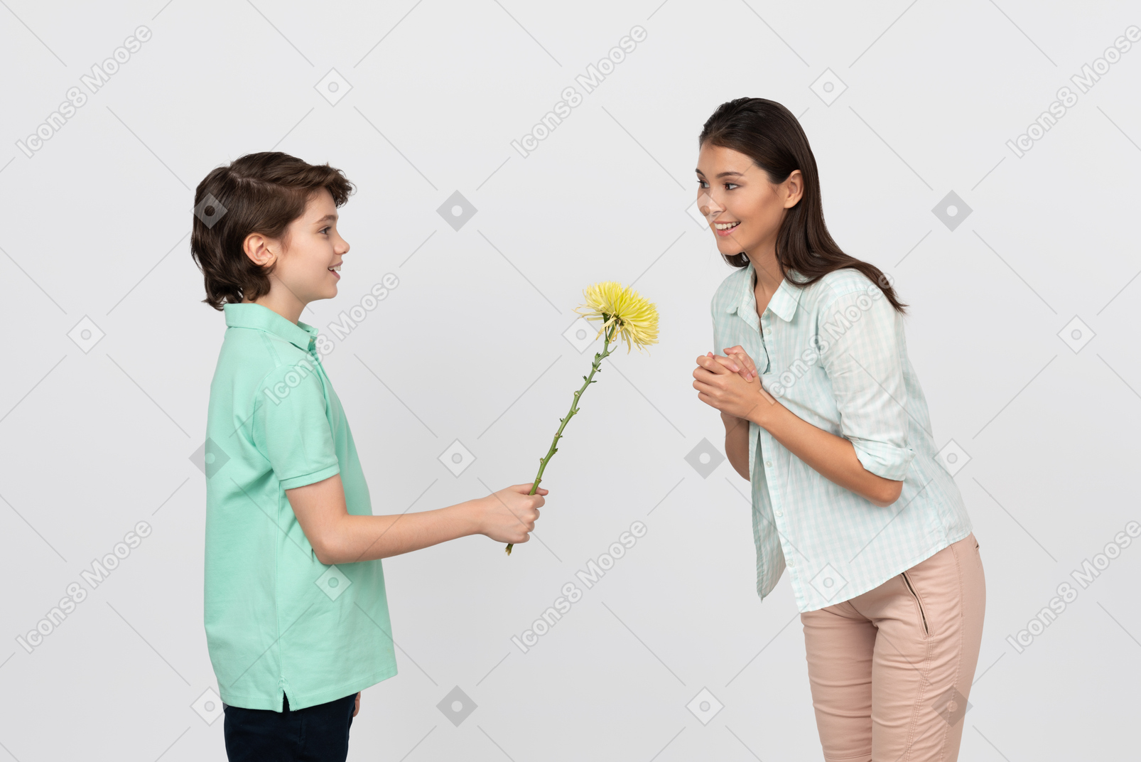 Attractive boy giving a flower to his mom