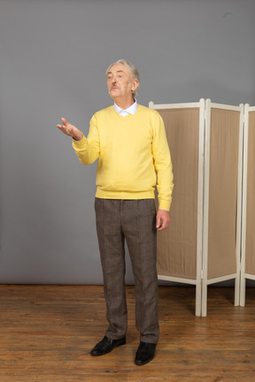 Three-quarter view of an old man sending an air kiss