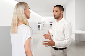 A man and woman talking in an office