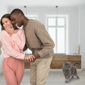 A man and woman laughing in a living room