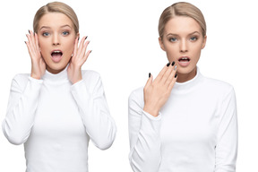 Surprised twin sisters in white turtlenecks