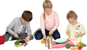 Children preparing lunch of faux vegetables