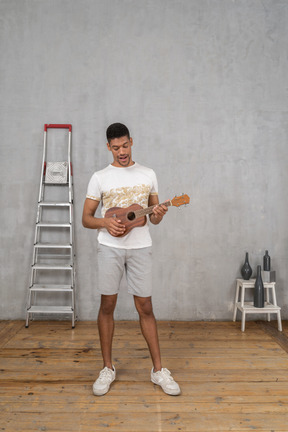 Front view of a man playing ukulele