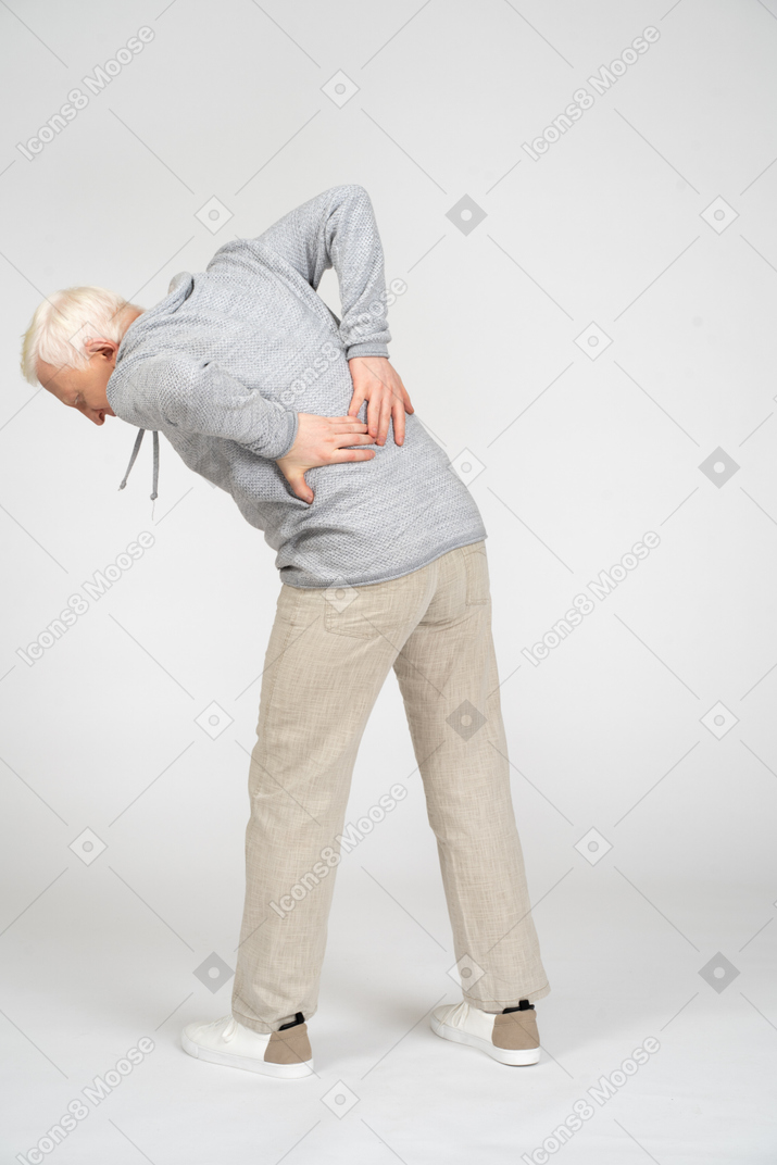 Man with hands on lower back leaning forward