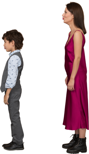 Woman in red dress and boy in grey suit vest in profile