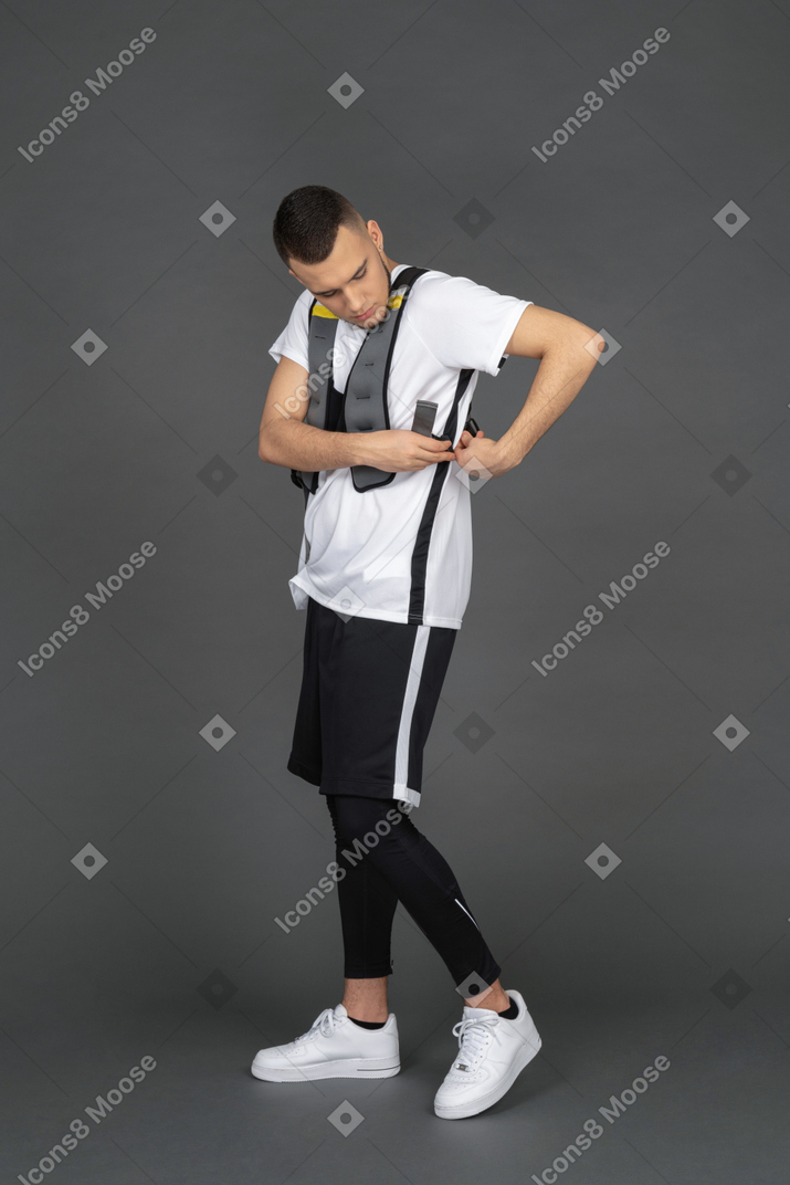 Young man fitting sport equipment
