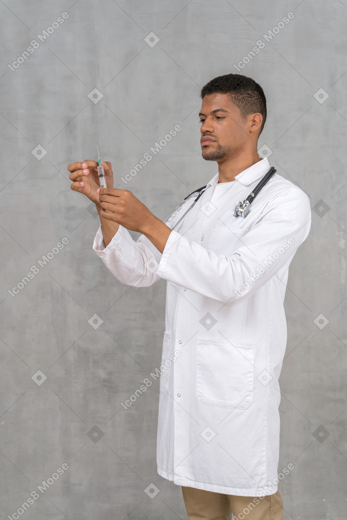 Male doctor preparing a syringe