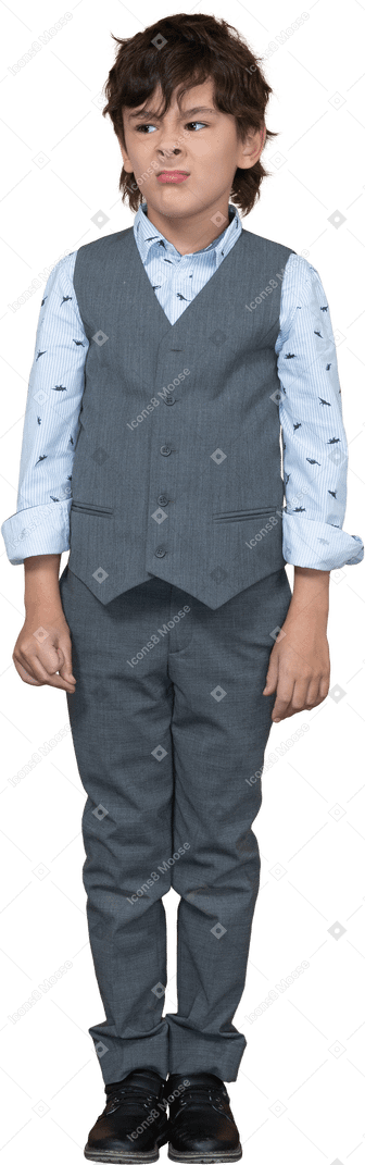Front view of a cute boy in grey suit making faces