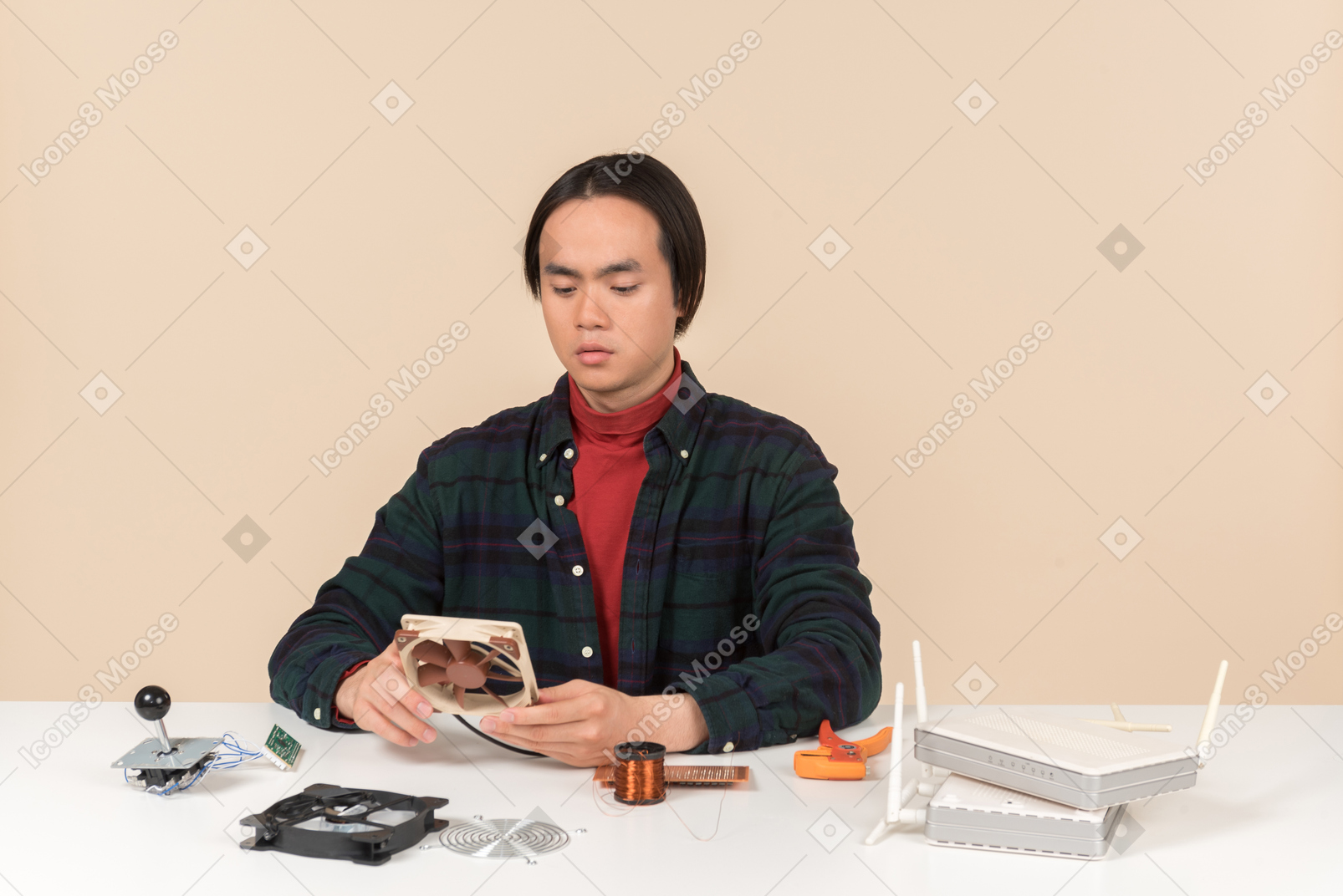 An asian geek guy in a dark checkered shirt, working with computer details
