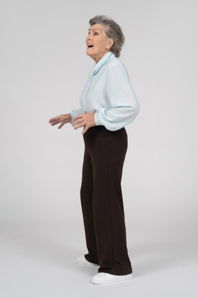 Side view of an old woman looking up nervously