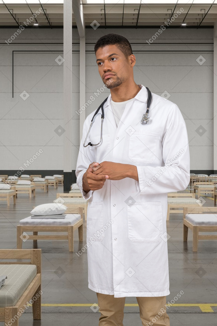 A doctor standing on a hospital background