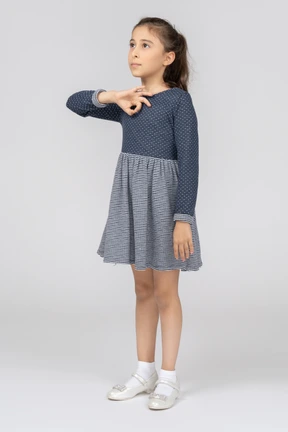 Little girl in dress showing ok sign