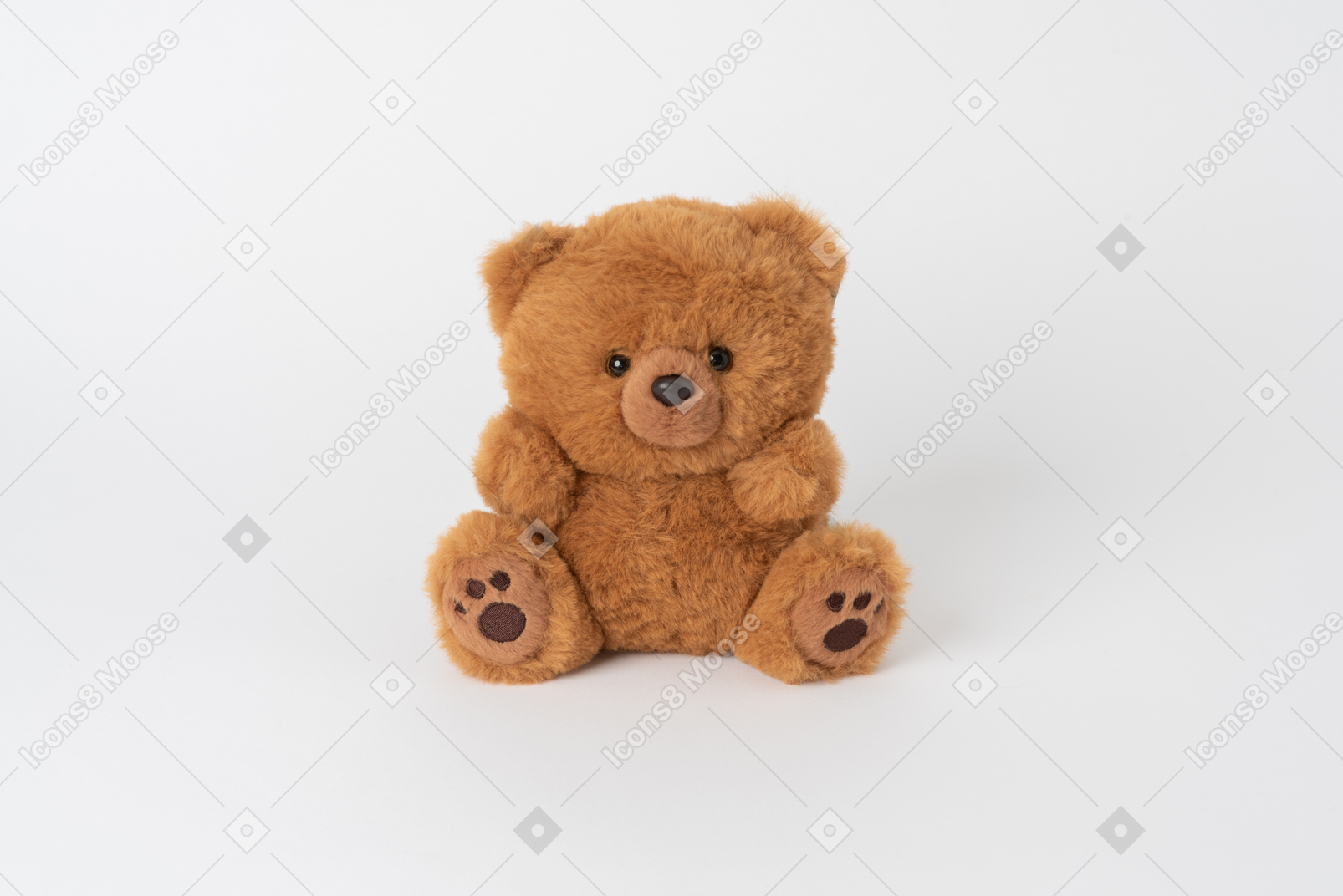 A little cute brown teddy bear sitting isolated against a plain white background