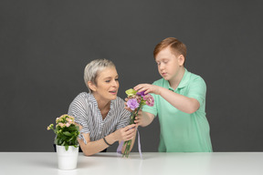 Mother and son making bouquet