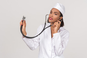 Attractive young female doctor holding a stethoscope