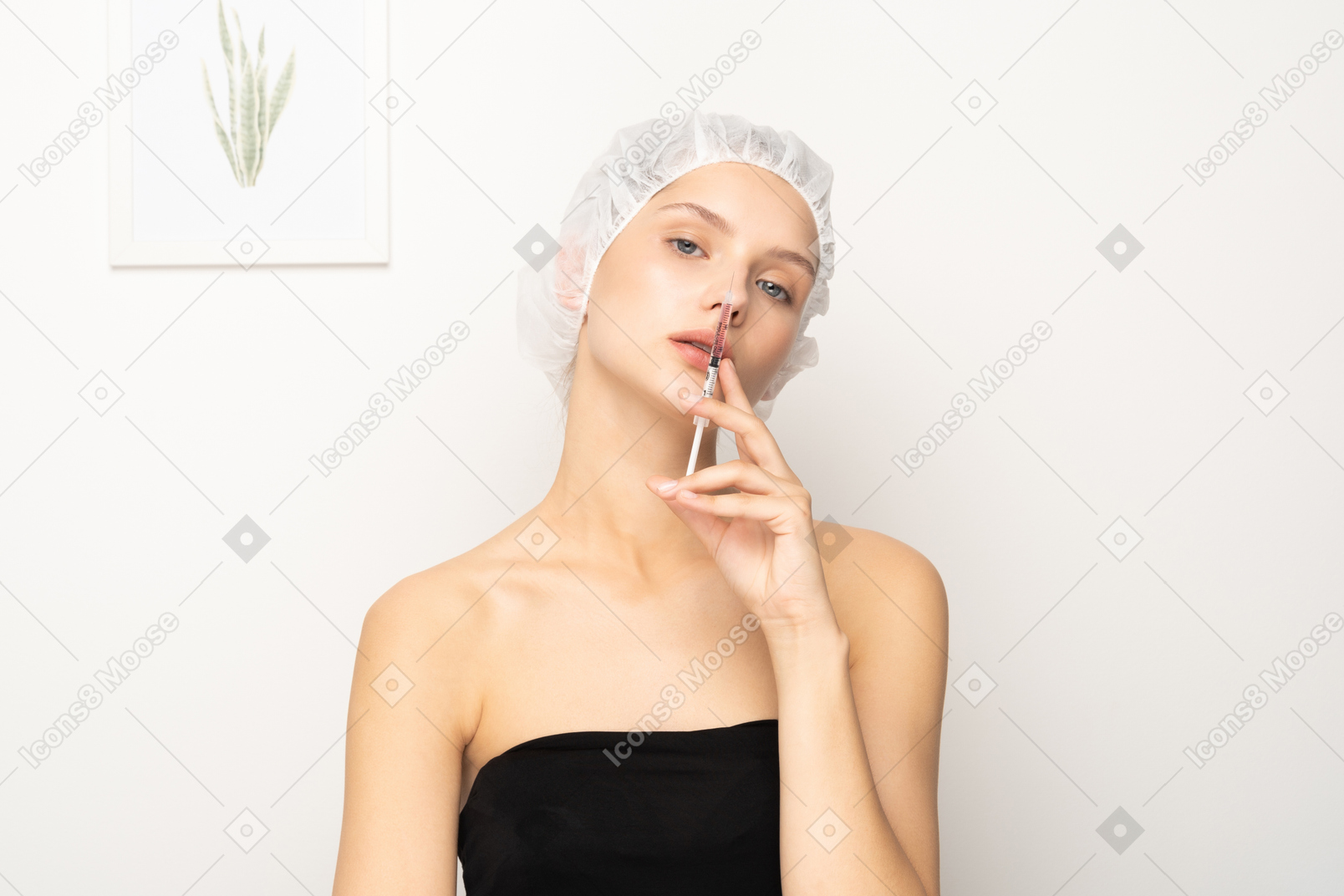 Young woman with syringe looking at camera