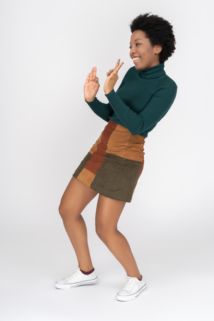 Smiling afro-american girl making ok gesture with both hands