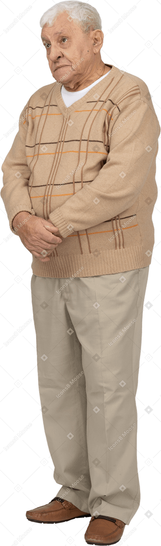 Front view of an old man in casual clothes looking up