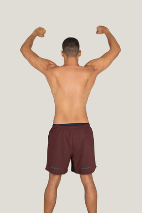 Back view of strong man showing his biceps