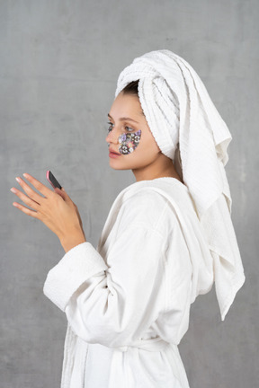 Side view of a woman filing her nails