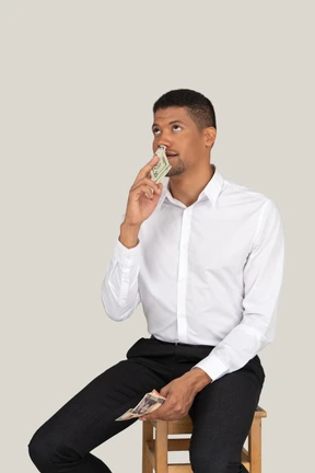 Businessman sniffing money