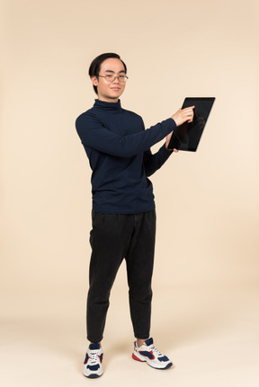 Young asian man presenting a digital tablet