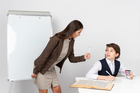 Angry young teacher and ignoring student