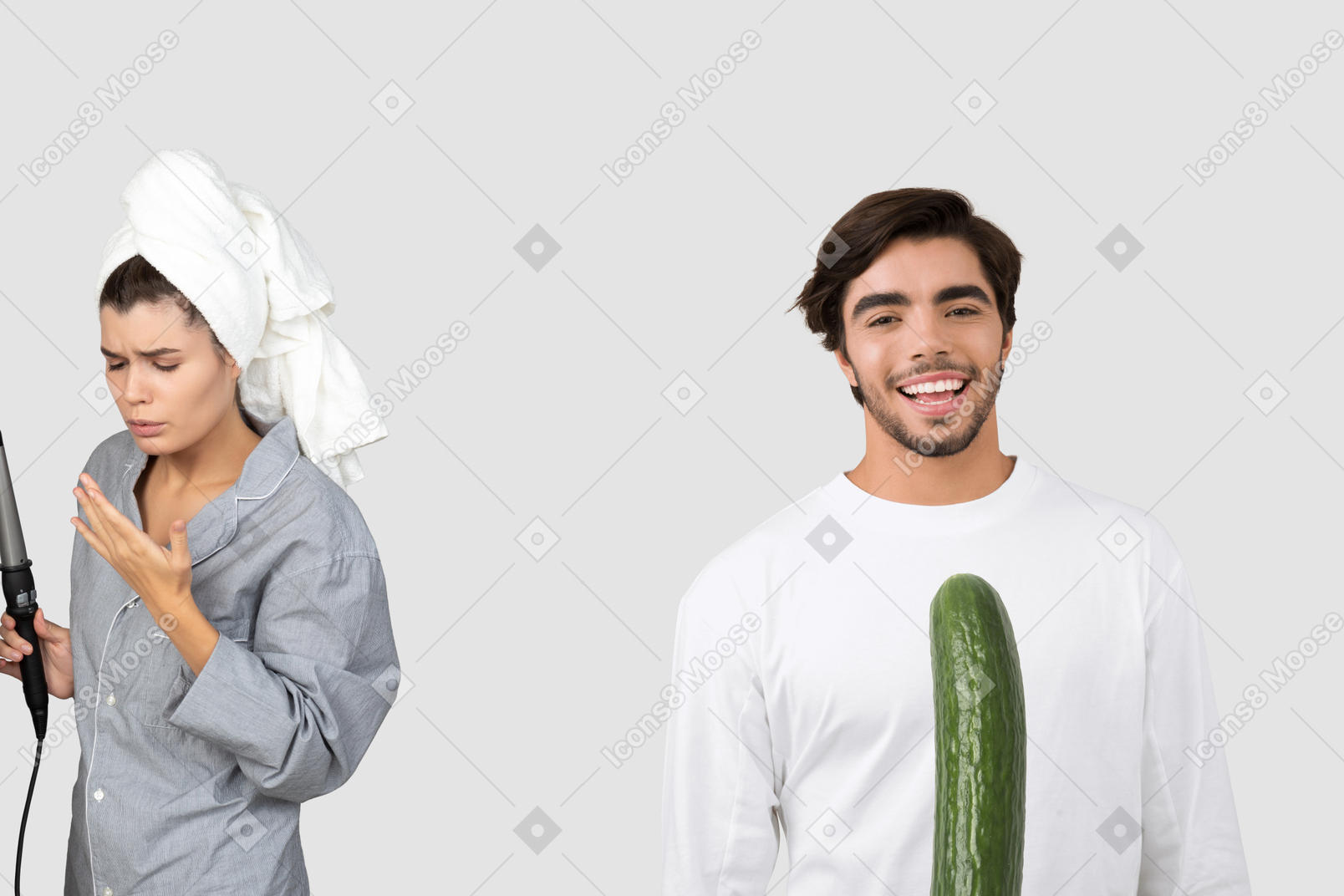 A woman with a hair curler and a man with a cucumber in front of him