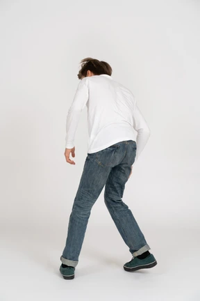 Young man in casual clothes dancing