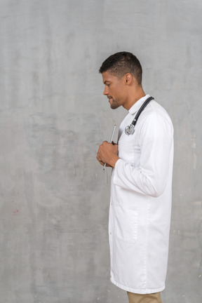 Side view of a solemn-looking doctor