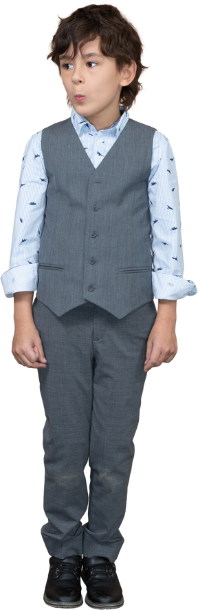 Front view of a cute boy in suit looking aside