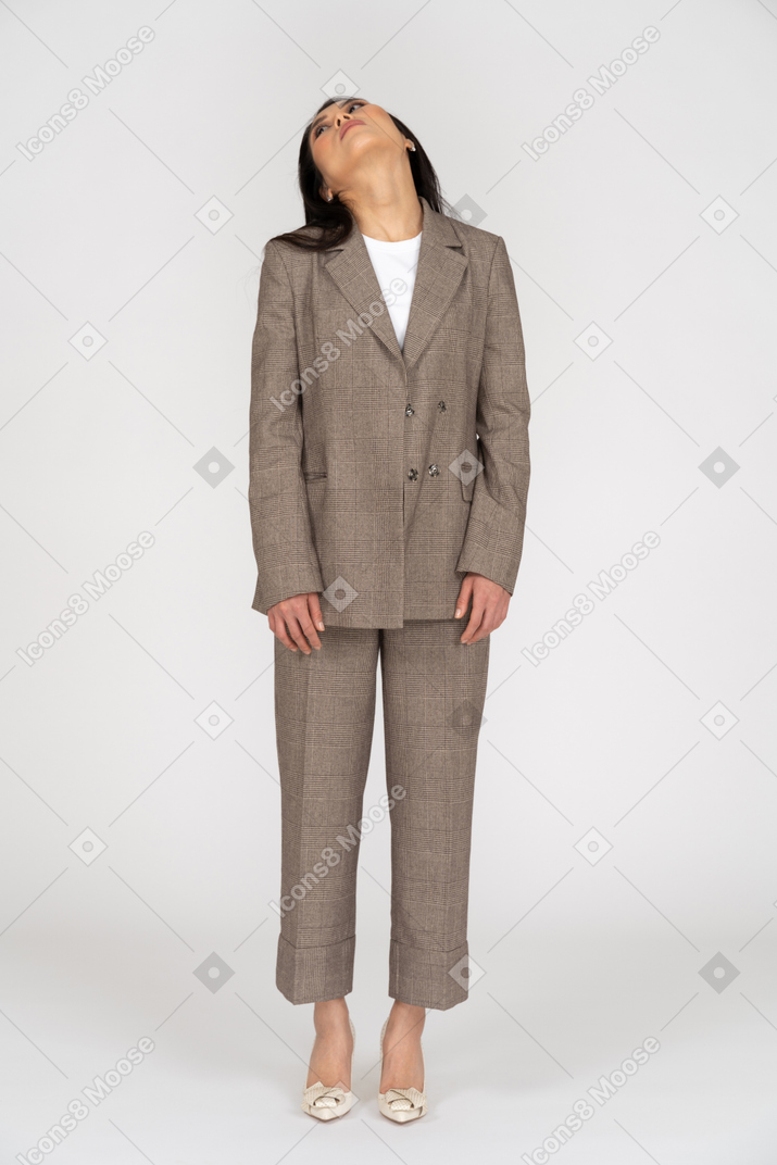 Front view of a young lady in brown business suit throwing head back
