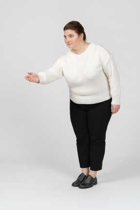 Plump woman in casual clothes giving a hand for shake