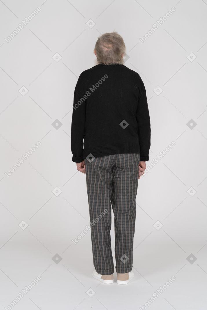 Back view of an old man standing still