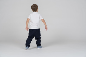 Back view of a boy walking forward