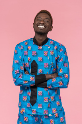 Black man in blue pajamas smiling