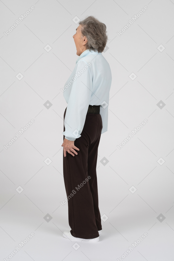 Three-quarter back view of an old woman gaping