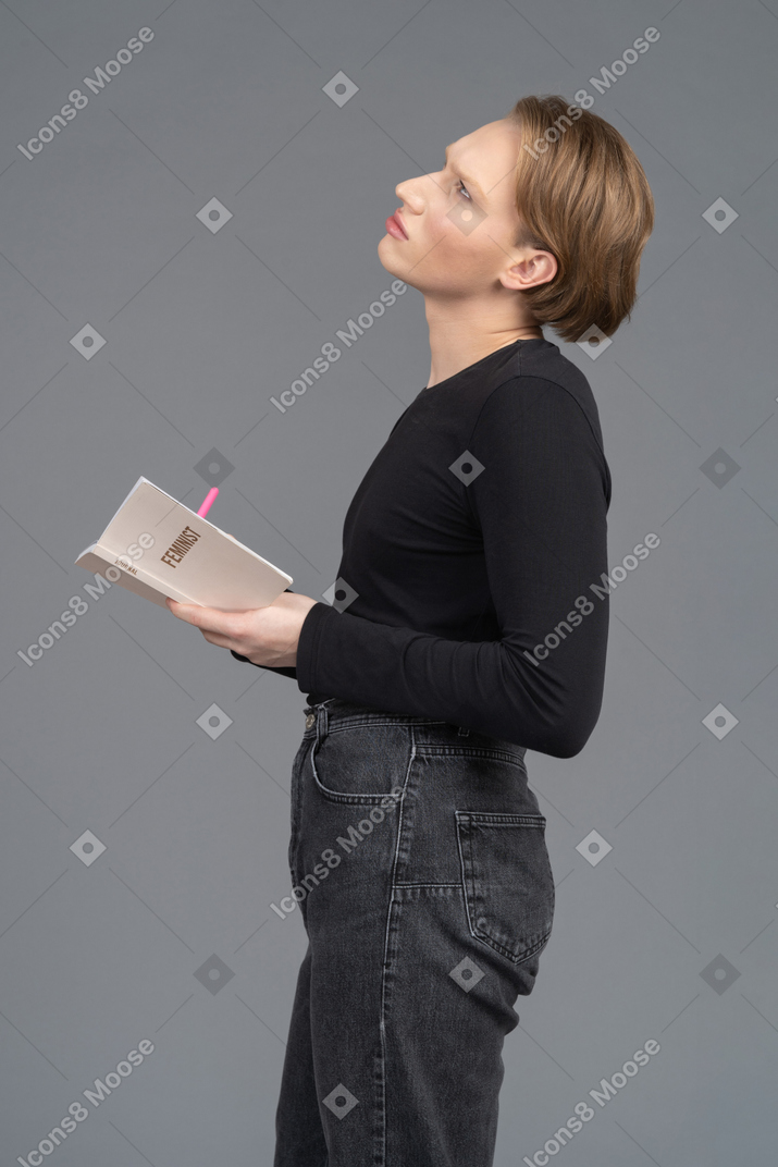 Side view of a person thinking about what to write