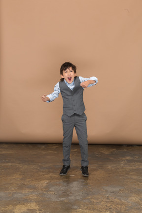 Front view of a boy in suit dancing