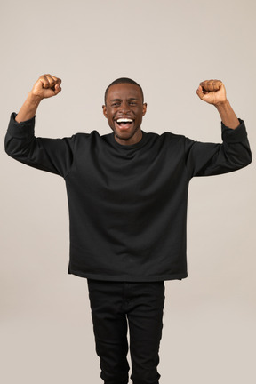 Happy young man celebrating something