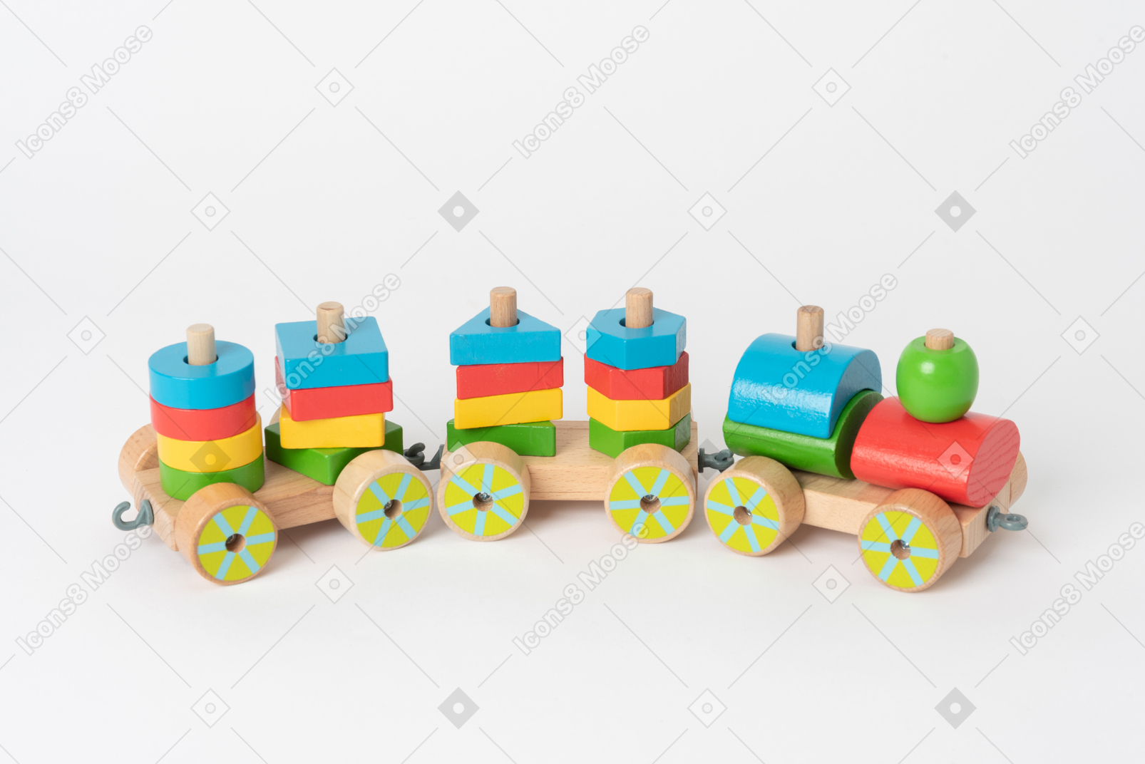 A colorful wooden toy train and geometrical shapes of many colors, lying against a plain white background
