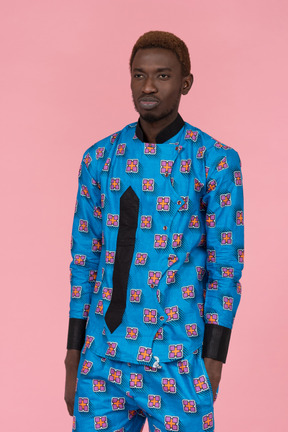 Black man in blue pajamas standing